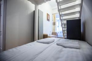 a bedroom with a bed with two towels on it at keleti apartment city center big flat bedroom private use in Budapest