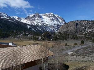 a view of a snowy mountain range with a house at Rr-interlaken 05 in June Lake