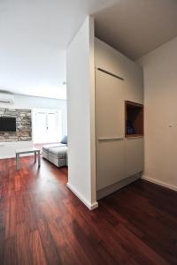 an empty living room with a couch and a tv at Historic center shelter in Piran