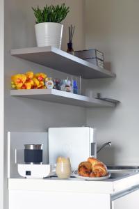 a plate of bread and fruit on a counter at I Giardini Di Zelda in Policoro +19 photos