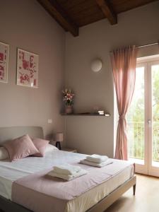 Ein Bett oder Betten in einem Zimmer der Unterkunft I Giardini Di Zelda