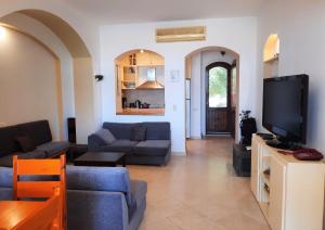 a living room with couches and a flat screen tv at Villa Melody - Holiday home in El Gouna in Hurghada