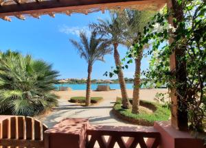 a view of the beach from a resort with palm trees at Villa Melody - Holiday home in El Gouna in Hurghada