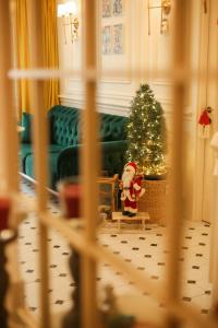 a christmas room with a christmas tree and a santa clause at Boutique Apartment - Signature in Kutaisi