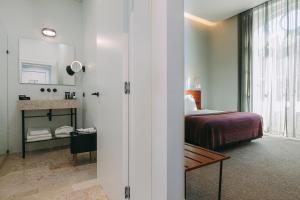 Postel nebo postele na pokoji v ubytování 1908 Lisboa Hotel