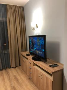 a flat screen tv sitting on top of a wooden cabinet at Mi Casa apartment in Veliko Tŭrnovo
