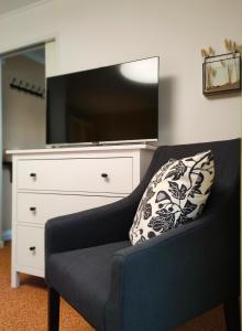 a living room with a couch and a large tv at Appartement RügenZeit in Lancken-Granitz