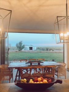a table with a bowl of fruit on it at Britskraal Guest Farm in Strydenburg +22 photos