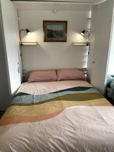 a bedroom with a bed with a colorful blanket on it at Self-catering studio in beautiful Charmouth in Charmouth