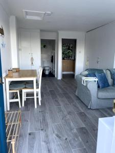 a living room with a table and a couch at Self-catering studio in beautiful Charmouth in Charmouth