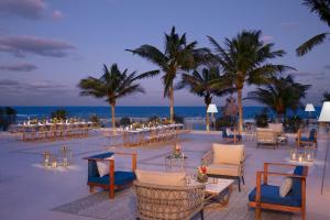 a wedding reception on the beach with tables and chairs at Dreams Aventuras Riviera Maya - All Inclusive in Puerto Aventuras