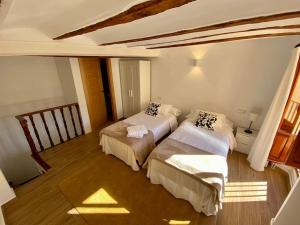 a bedroom with two beds in a room at VILLA SOL Casa con cueva privada y vistas a la Iglesia in Requena