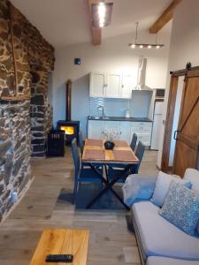 a living room with a table and a couch and a kitchen at A Nosa Casa 2 in Belesar