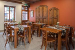 a dining room with wooden tables and chairs at Hotel Czarna Róża in Toruń