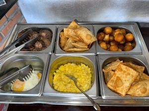 a tray filled with different types of breakfast foods at Tijota Hotel Fazenda in Ipatinga
