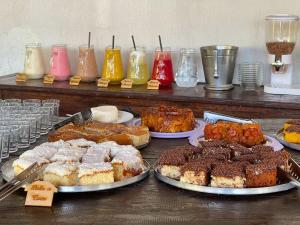 a table topped with different types of cakes and pastries at Tijota Hotel Fazenda in Ipatinga