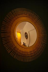 a mirror reflecting a room with a clock in it at CHARMANT STUDIO☆NETFLIX☆CANAL+☆CANAL SAT☆PARKING☆ in Ramonville-Saint-Agne +45 photos