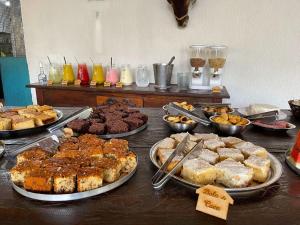 a table with many different types of pastries and desserts at Tijota Hotel Fazenda in Ipatinga