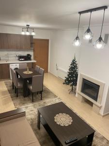 a living room with a table and a christmas tree at Гранд Манастира , Пампорово in Pamporovo