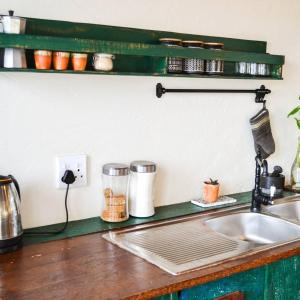 a kitchen counter with a sink and a counter top at Pura Vida Tofo Beach Houses in Praia do Tofo