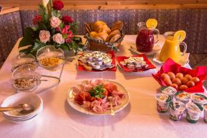 a table with a buffet of food and fruit at GARNI AQUILA in Corvara in Badia