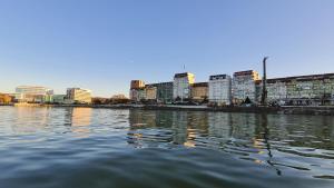 a large body of water with buildings in the background at Diana Sunshine Apartment in Tulcea