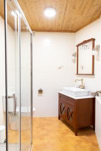 uma casa de banho com um lavatório e um chuveiro em As Veneiras Casa Rural em Neipín