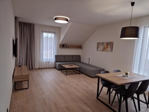 a living room with a couch and a table at JBX Resort Avenue Lipno in Lipno nad Vltavou
