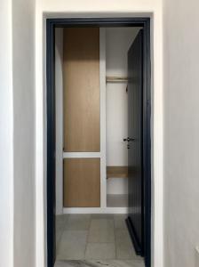 an open door to a room with a closet at Psili Ammos in Mylopotas