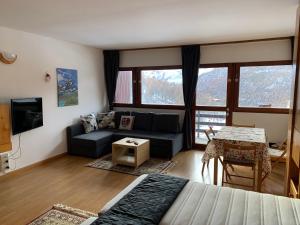 a living room with a couch and a table at Cervinia Apartment 2112 in Breuil-Cervinia