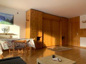 a living room with wooden cabinets and a table at Cervinia Apartment 2112 in Breuil-Cervinia