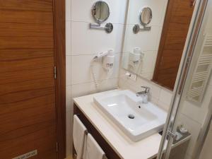 a bathroom with a sink and a mirror at Apartment B326 - Aparthotel Vučko in Jahorina