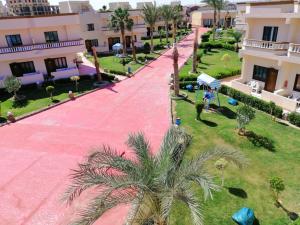 a large building with a lot of green grass at Bella Rose Nefertiti in Hurghada
