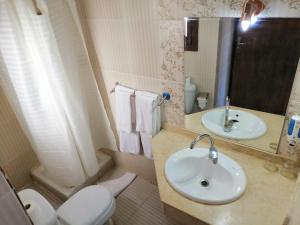 a bathroom with a sink, toilet and mirror at Bella Rose Nefertiti in Hurghada