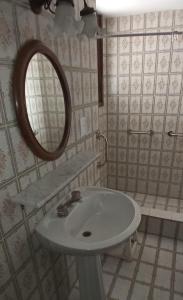 a bathroom with a sink and a mirror at Hostel Casteleyhost in Mendoza
