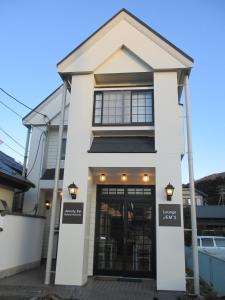 箱根的住宿－傑姆斯帝箱根蘆湖畔住宿加早餐旅館，前面有一扇门的白色房子