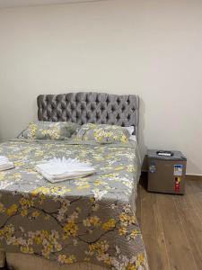 a bedroom with a bed with a gray headboard at Pousada Paraiso de Igaratá in Igaratá +71 photos