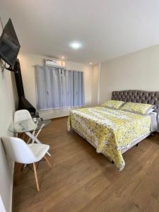 Un pat sau paturi într-o cameră la Pousada Paraiso de Igaratá