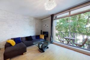 sala de estar con sofá y ventana grande en Superb 3 bed flat with balcony in St John's Wood en Londres