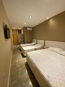 a bedroom with two beds and a tv in it at Paraiso Natural Apart & Hotel Iguazu in Puerto Iguazú +71 photos