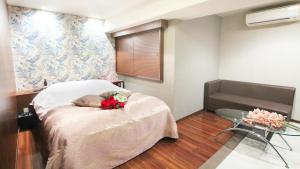 a bedroom with a bed with flowers on it at agehA - Adult Only- in Fukuyama