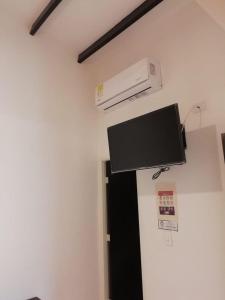 a flat screen tv on a wall in a room at HOTEL BLACK & WHITE in Cali +29 photos