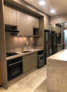 a large kitchen with stainless steel appliances in at Apartment Ipanema Arpoador - 300m da praia in Rio de Janeiro