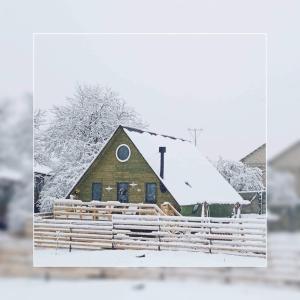 a picture of a barn covered in snow at Wooden cottage "green house" in Bakuriani in Bakuriani