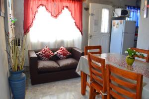 a living room with a couch and a table at Eluney Apart in Villa Giardino