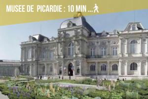 a large building with a garden in front of it at Black Pearl Suite Luxe Centre-Ville Amiens à 200m de la Cathédrale in Amiens
