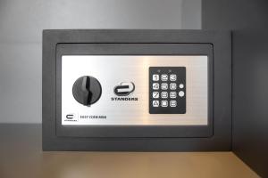 a microwave oven with a remote control on it at Black Pearl Suite Luxe Centre-Ville Amiens à 200m de la Cathédrale in Amiens