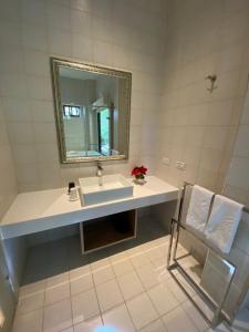 a bathroom with a sink and a mirror and a chair at The fairy land - Lala Mountain in Fuxing