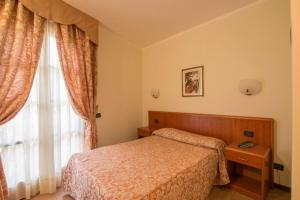 Letto o letti in una camera di Albergo Giardino