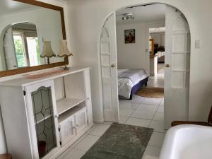 a bedroom with a mirror and a bed in a room at Eumundi Guesthouse and B&B in Eumundi